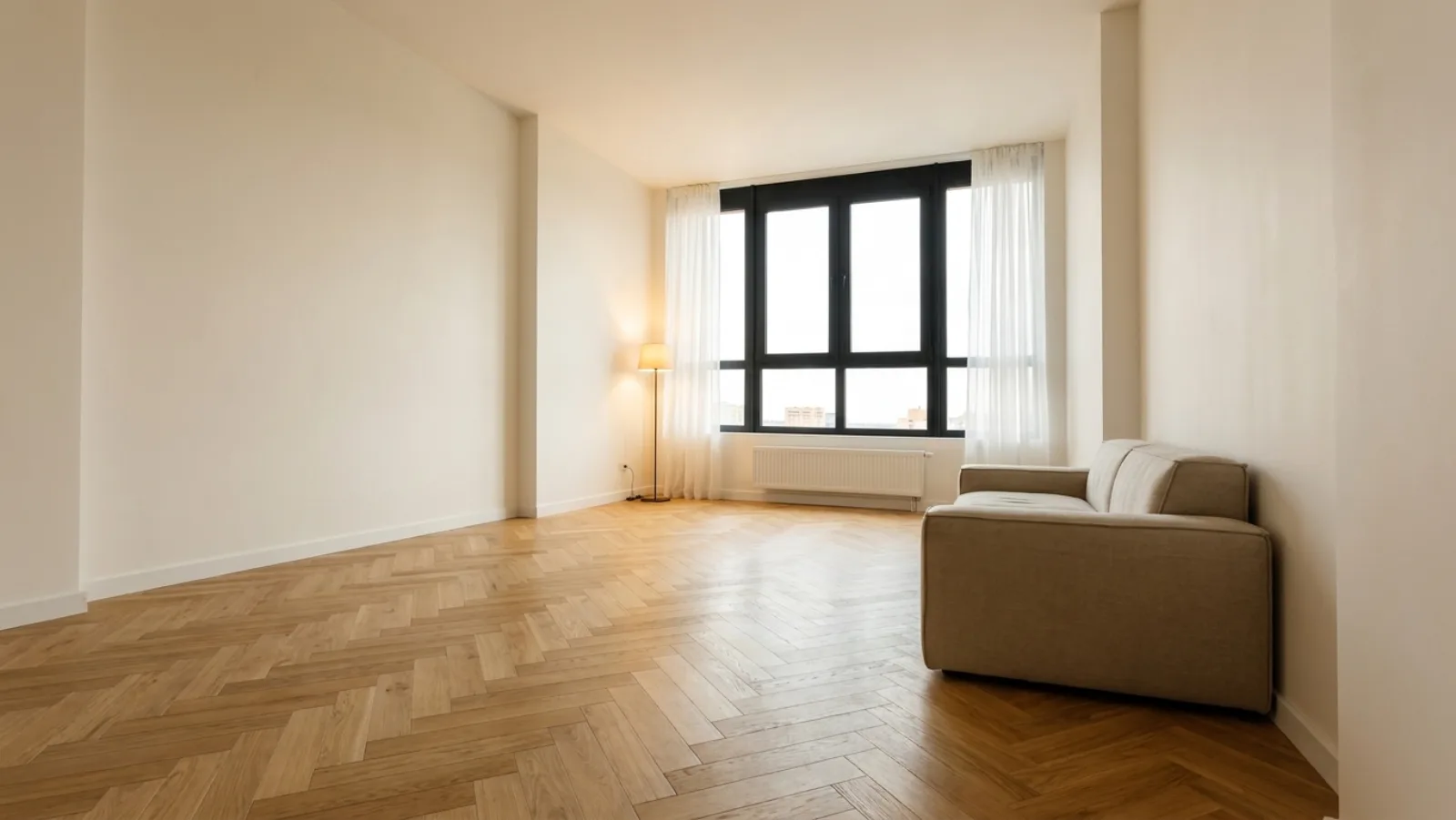 Dezelfde woonkamer na de renovatie: gestuukt, visgraatvloer, nieuw kozijn